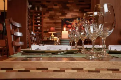 a table with wine glasses on top of it at Casa del Sol Machupicchu in Machu Picchu