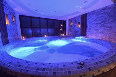 a large jacuzzi tub in a room with lights at Casa del Sol Machupicchu in Machu Picchu
