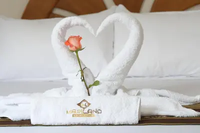 a towel animal shaped like swans on a bed at MAPILAND- Hotel Boutique in Machu Picchu