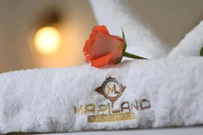 a red rose sitting on top of a white towel at MAPILAND- Hotel Boutique in Machu Picchu