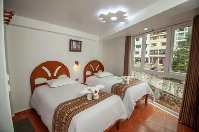 a bedroom with two beds with teddy bears on them at MAPILAND- Hotel Boutique in Machu Picchu