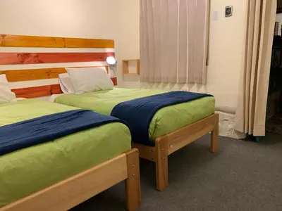 two beds in a hotel room at Gaia House Hostel in Cusco