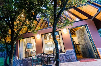 a house with trees in front of it at VILLA APU CHICON (Apu Wasi & Inti Wasi) in Urubamba