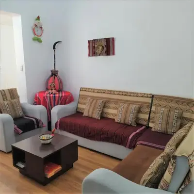 a living room with a couch and a table at Piso de Kireyna in Cusco
