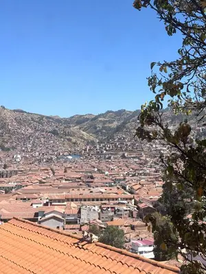 a view of a city with houses and mountains at Welcome Cusco Hostel in Cusco