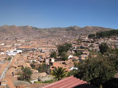 a view of a city with houses and mountains at Welcome Cusco Hostel in Cusco