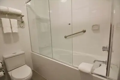 a bathroom with a toilet and a glass shower at Tierra Viva Miraflores Centro in Lima