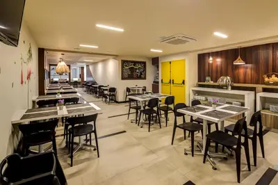 a restaurant with tables and chairs in a room at Arawi Miraflores Express in Lima