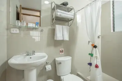 a bathroom with a white toilet and a sink at Casa Matara Boutique in Cusco