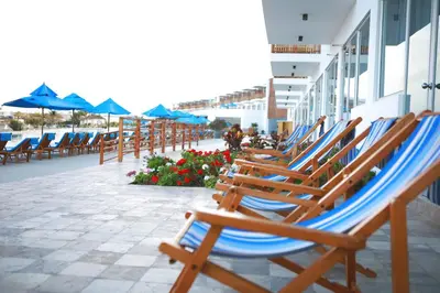 a row of chairs and umbrellas on a beach at San Agustin Paracas in Paracas