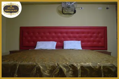 a large bed with a red headboard in a bedroom at Dubai Palace in Lima