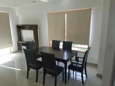a dining room with a black table and chairs at Jirón Tarapacá 398, La Punta - Callao in Lima