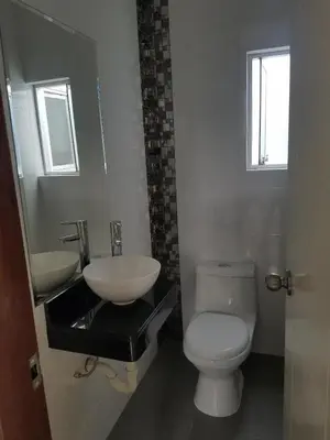 a bathroom with a white toilet and a sink at Jirón Tarapacá 398, La Punta - Callao in Lima