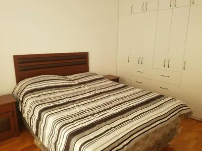 a bedroom with a bed and a dresser and cabinets at Jirón Tarapacá 398, La Punta - Callao in Lima