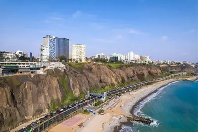 a view of a beach with a city and buildings at AC Hotel by Marriott Lima Miraflores in Lima