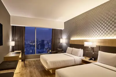 a hotel room with two beds and a window at AC Hotel by Marriott Lima Miraflores in Lima