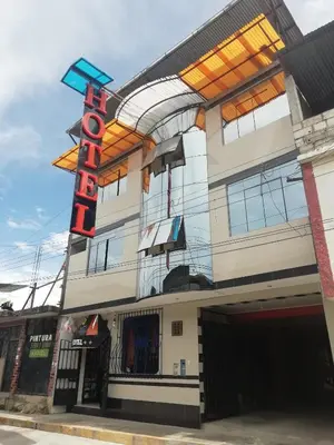 a building with a sign for a store at Refugio Hotel in San Ramón