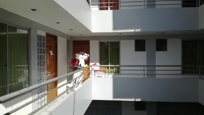 a person standing on the balcony of a building at Hotel Villa Santa Ana in Quillabamba