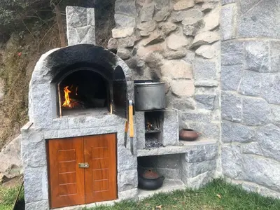 a stone oven with a door and a fire place at Casa Campo Machu Picchu - Club Los Girasoles, Chaclacayo in Chaclacayo