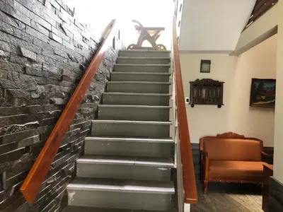 a staircase in a house with a brick wall at Casa Campo Machu Picchu - Club Los Girasoles, Chaclacayo in Chaclacayo