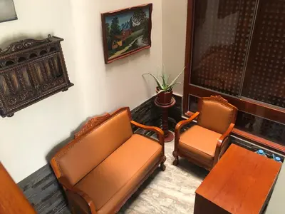 a living room with two chairs and a table at Casa Campo Machu Picchu - Club Los Girasoles, Chaclacayo in Chaclacayo