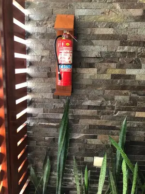 a fire extinguisher on top of a brick wall at Casa Campo Machu Picchu - Club Los Girasoles, Chaclacayo in Chaclacayo