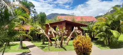 a resort with palm trees and a building at Chontaqui Eco-Lodge in Oxapampa