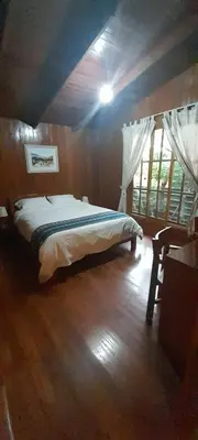 a bedroom with a bed in a room at Chontaqui Eco-Lodge in Oxapampa