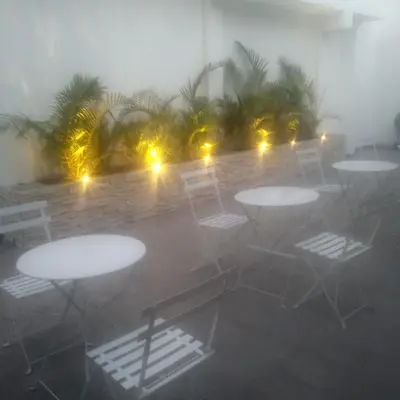 a group of tables and chairs in a room with fog at Coco Lodge Paracas in Paracas