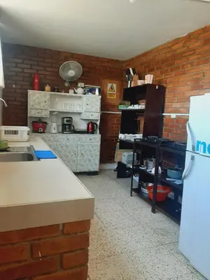 a kitchen with a brick wall at Casa Montemira in Ica