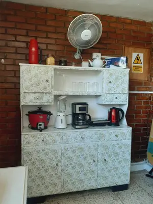 a kitchen counter with a fan on a brick wall at Casa Montemira in Ica