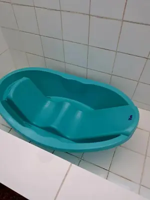 a blue bath tub sitting on a tiled floor at Casa Montemira in Ica