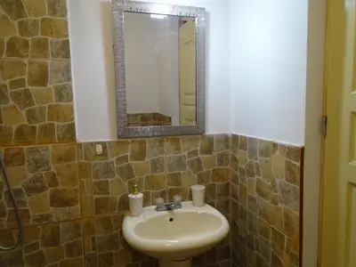 a bathroom with a sink and a mirror at Peruvian Family Hostal Miraflores in Lima