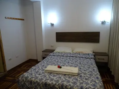 a bedroom with two beds with towels on it at Peruvian Family Hostal Miraflores in Lima