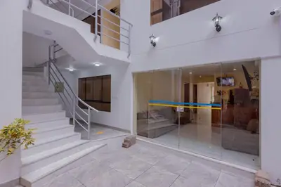 a staircase in a building with glass walls at Hawka Inka Hostal - Cusco in Cusco