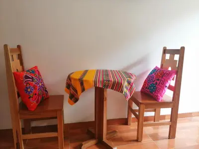 a table and two chairs with a blanket on them at Kenti's Home Ollantaytambo in Ollantaytambo