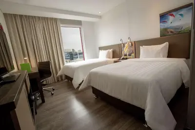 a hotel room with two beds and a window at Hampton By Hilton Lima San Isidro in Lima