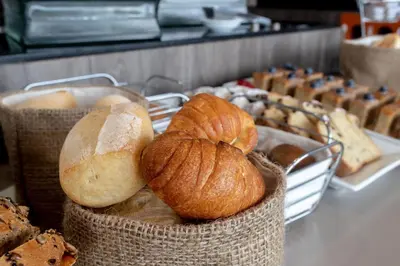 a bunch of breads and pastries on a table at Hampton By Hilton Lima San Isidro in Lima