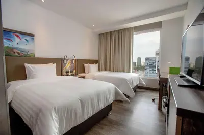 a hotel room with two beds and a window at Hampton By Hilton Lima San Isidro in Lima