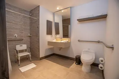 a bathroom with a toilet and a sink and a shower at Hampton By Hilton Lima San Isidro in Lima