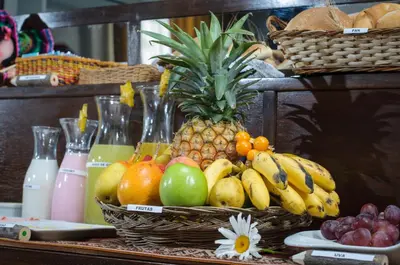 a bunch of fruit in baskets on a table at Posada San Blas in Cusco