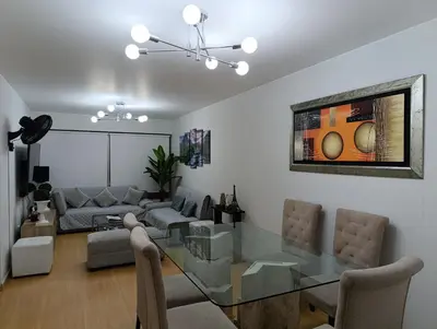 a dining room and living room with a glass table at MIRAFLORES APART-10Beds-11Persons-Pool-Grill-Garage-Near Kennedy Park in Lima