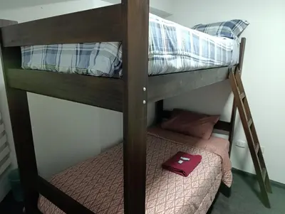 a bunk bed in a room with a small bed in a bunk room at MIRAFLORES APART-10Beds-11Persons-Pool-Grill-Garage-Near Kennedy Park in Lima
