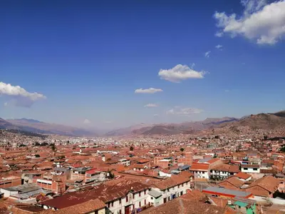 a view of a city with mountains in the background at El Balcón del Sol in Cusco