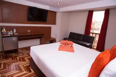 a hotel room with a bed with a bow on it at Hotel Arcangel in Cusco