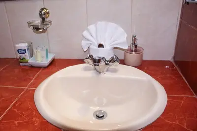 a bathroom sink with a roll of toilet paper on it at Hotel Arcangel in Cusco