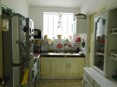 a kitchen with yellow cabinets and a refrigerator at Teté in Lima