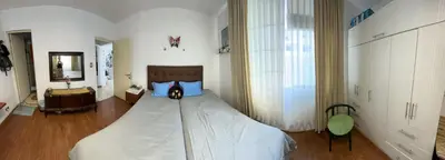 a bedroom with a large white bed with blue pillows at Teté in Lima