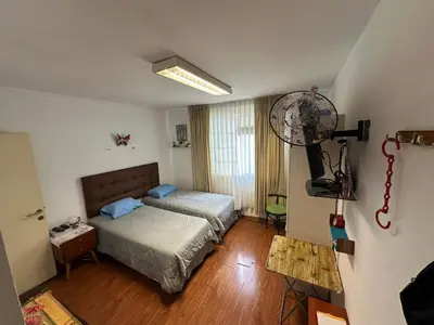 a bedroom with a bed and a television in it at Teté in Lima