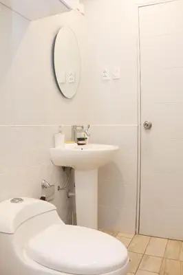 a bathroom with a toilet and a sink and a mirror at Casa 100% ecológica con vista a los glaciares andinos in Maras